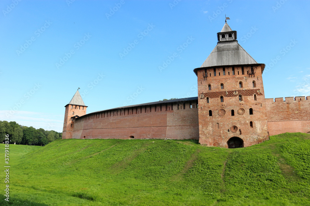 Spasskaya Tower at south side of the wall of the Velikiy (Great) Novgorod citadel (kremlin, detinets) in Russia under blue summer sky in the morning 