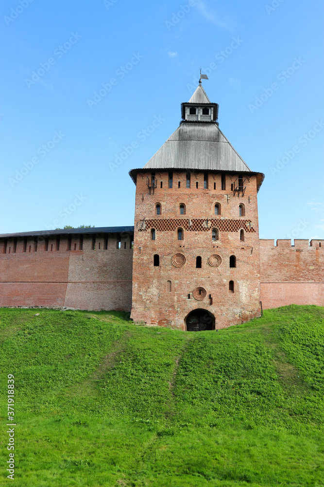 Spasskaya Tower at south side of the wall of the Velikiy (Great) Novgorod citadel (kremlin, detinets) in Russia under blue summer sky in the morning 