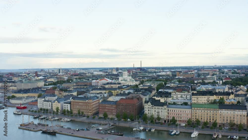 Slow aerial reverse shot of boats along the waterfront with Helsinki Cathedral in view, Finland. Slow aerial reverse shot of boats along the waterfront with Helsinki Cathedral in view, Finland.