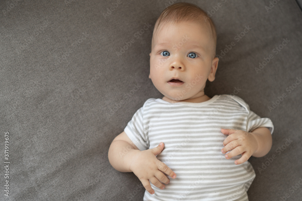 little newborn baby is resting on the sofa. Top view little newborn baby is resting on the sofa. Top view