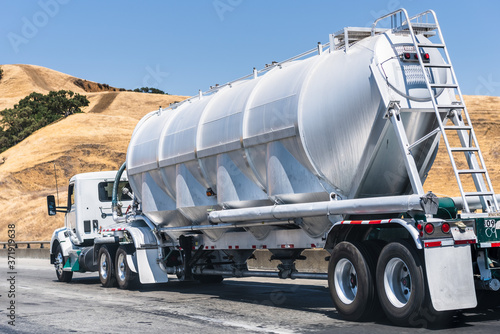 Tanker truck driving on the freeway through the hills of Alameda County, East San Francisco Bay Area, California