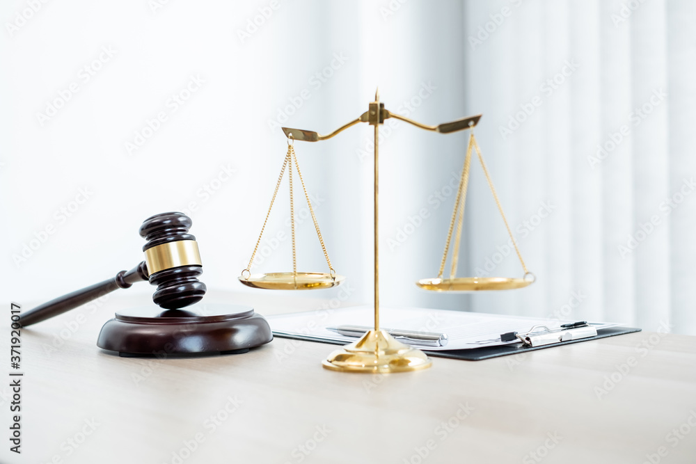 The judge's gavel at the law firm has scales, scales of justice, and litigation documents. Concepts of law and justice - obrazy, fototapety, plakaty 
