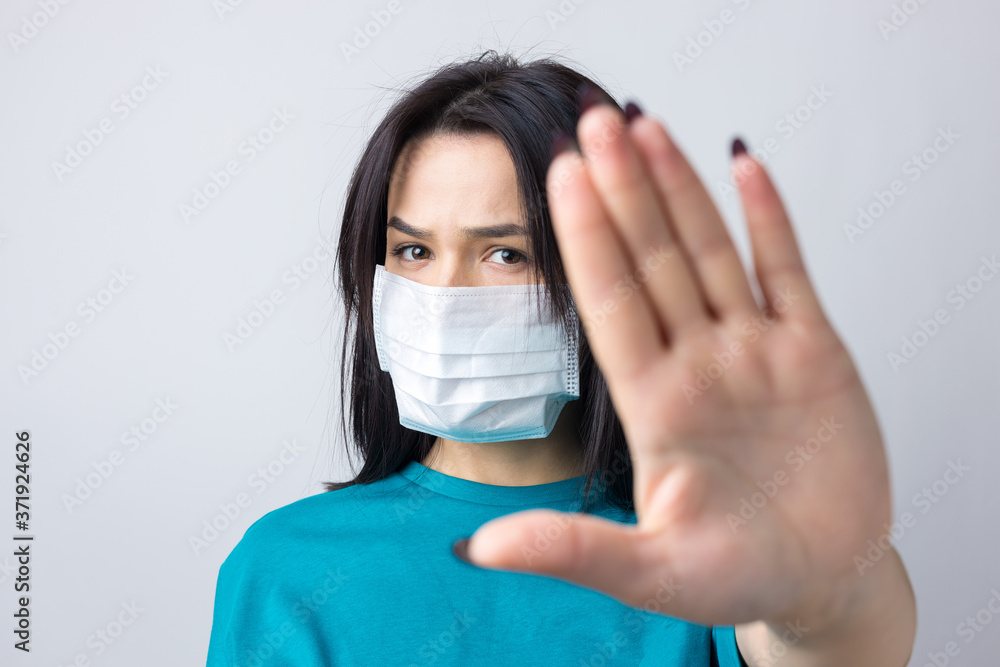 Portrait of anxious depressed girl feel fear about covid-19. Wear medical mask isolated over gray background. Portrait of anxious depressed girl feel fear about covid-19. Wear medical mask isolated over gray background.