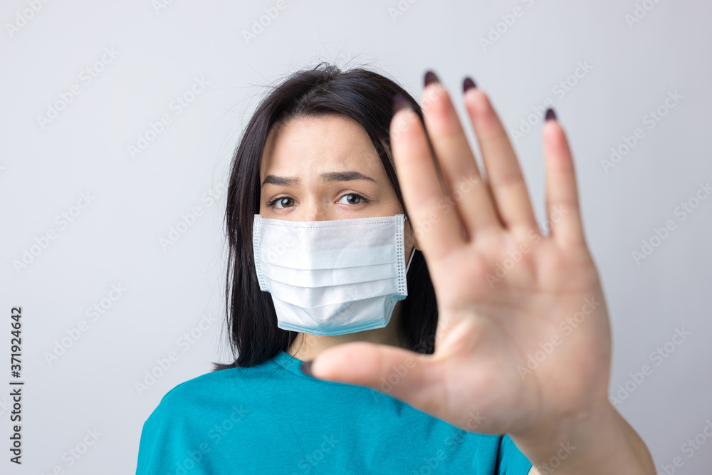 Portrait of anxious depressed girl feel fear about covid-19. Wear medical mask isolated over gray background. Portrait of anxious depressed girl feel fear about covid-19. Wear medical mask isolated over gray background.