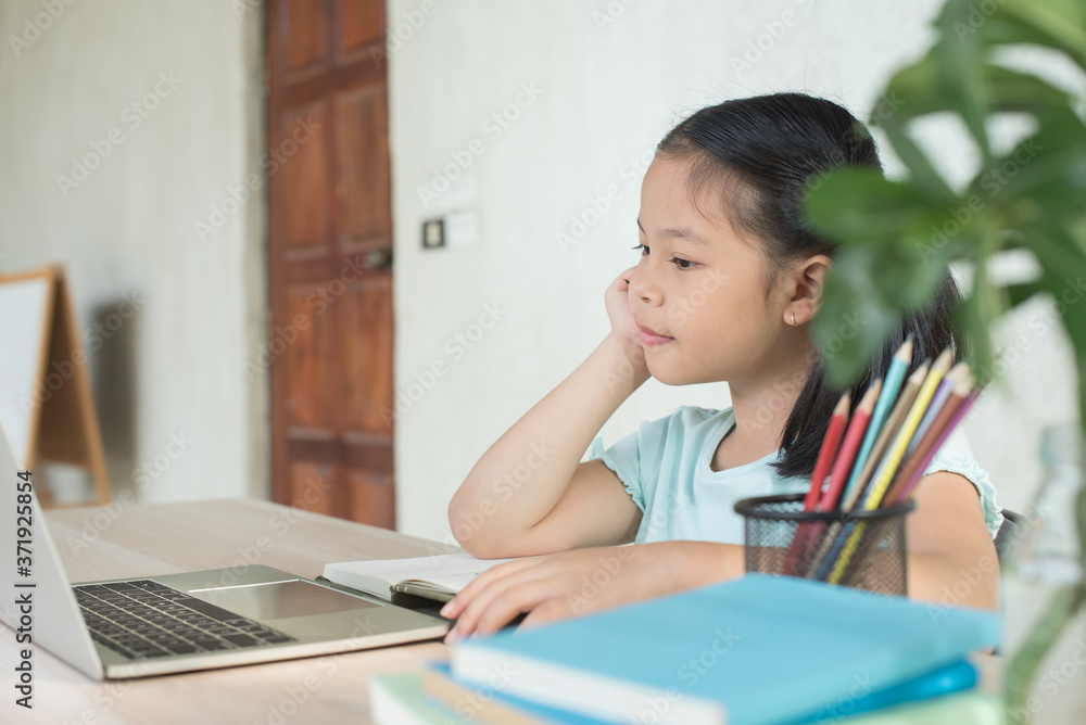 pretty stylish schoolgirl studying homework during online lesson at home, social distance during quarantine, self-isolation, online education concept, home school, study online video call teacher. pretty stylish schoolgirl studying homework during online lesson at home, social distance during quarantine, self-isolation, online education concept, home school, study online video call teacher.