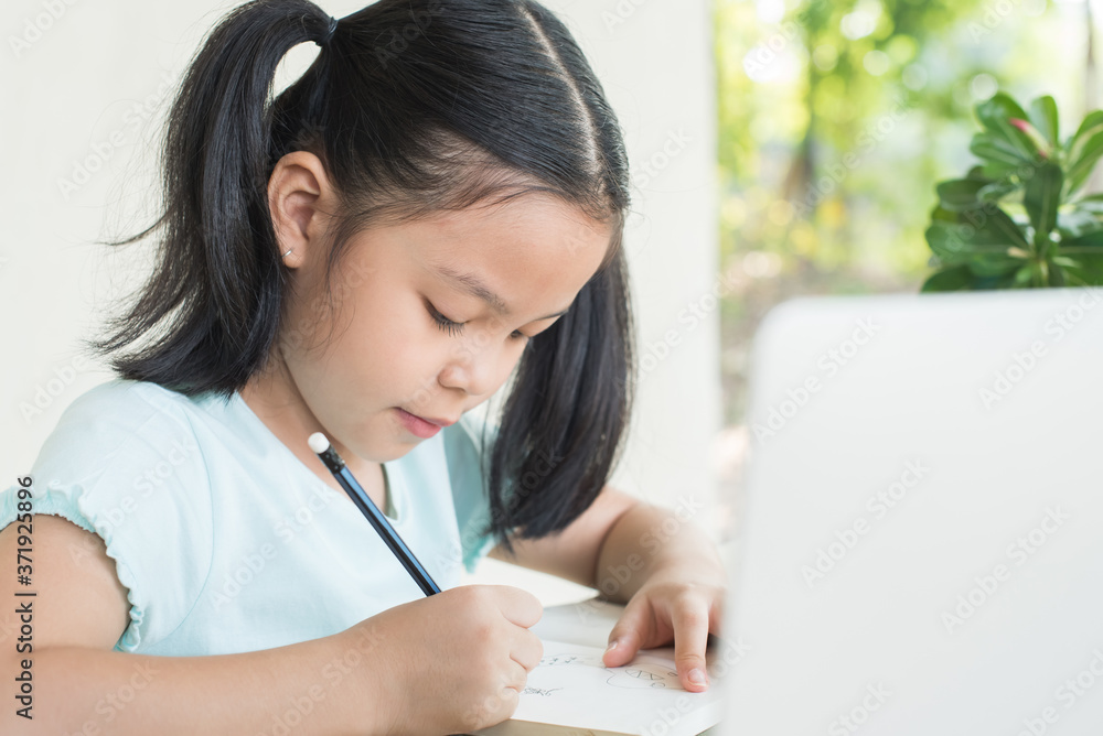 pretty stylish schoolgirl studying homework during online lesson at home, social distance during quarantine, self-isolation, online education concept, home school, study online video call teacher. pretty stylish schoolgirl studying homework during online lesson at home, social distance during quarantine, self-isolation, online education concept, home school, study online video call teacher.