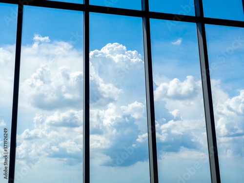 Beautiful clouds and blue sky through large windows  view from inside the building.