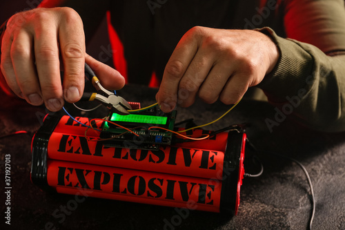 Принти на полотні Man defusing bomb at table, closeup