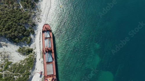 cargo ship that ran aground ran aground on the coast of the sea photo