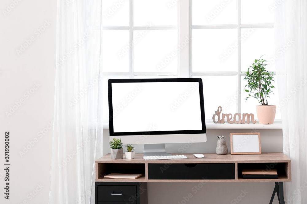 Fototapeta premium Modern workplace with computer near window in room