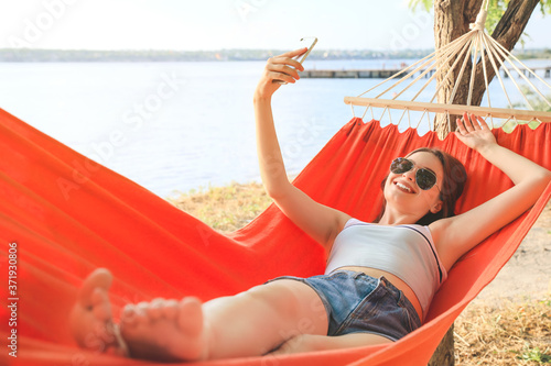 Young woman taking selfie w...