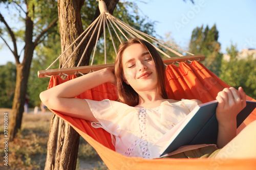 Young woman reading book wh...