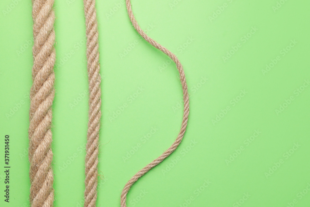 Long ropes on color background