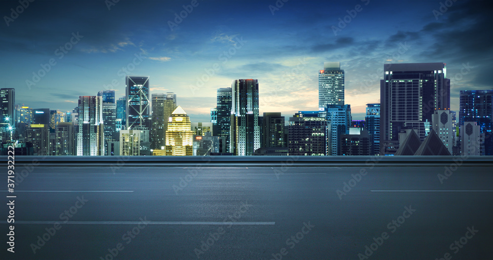 Empty asphalt road and cityscape skyline at night Empty asphalt road and cityscape skyline at night