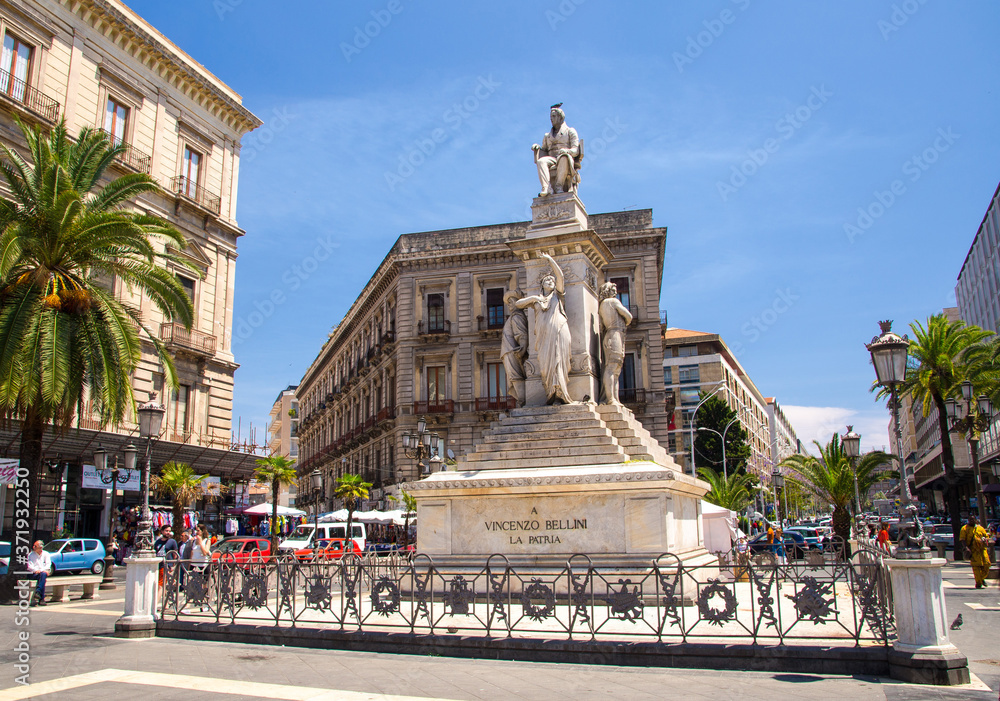 Italy, Catania, May 12, 2018: Monument to Vincenzo Bellini on Piazza Stesicoro Square with palm trees in city centre, Sicilia