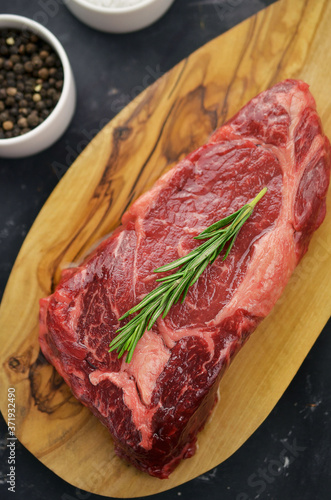 Raw entrecote steak on cutting board