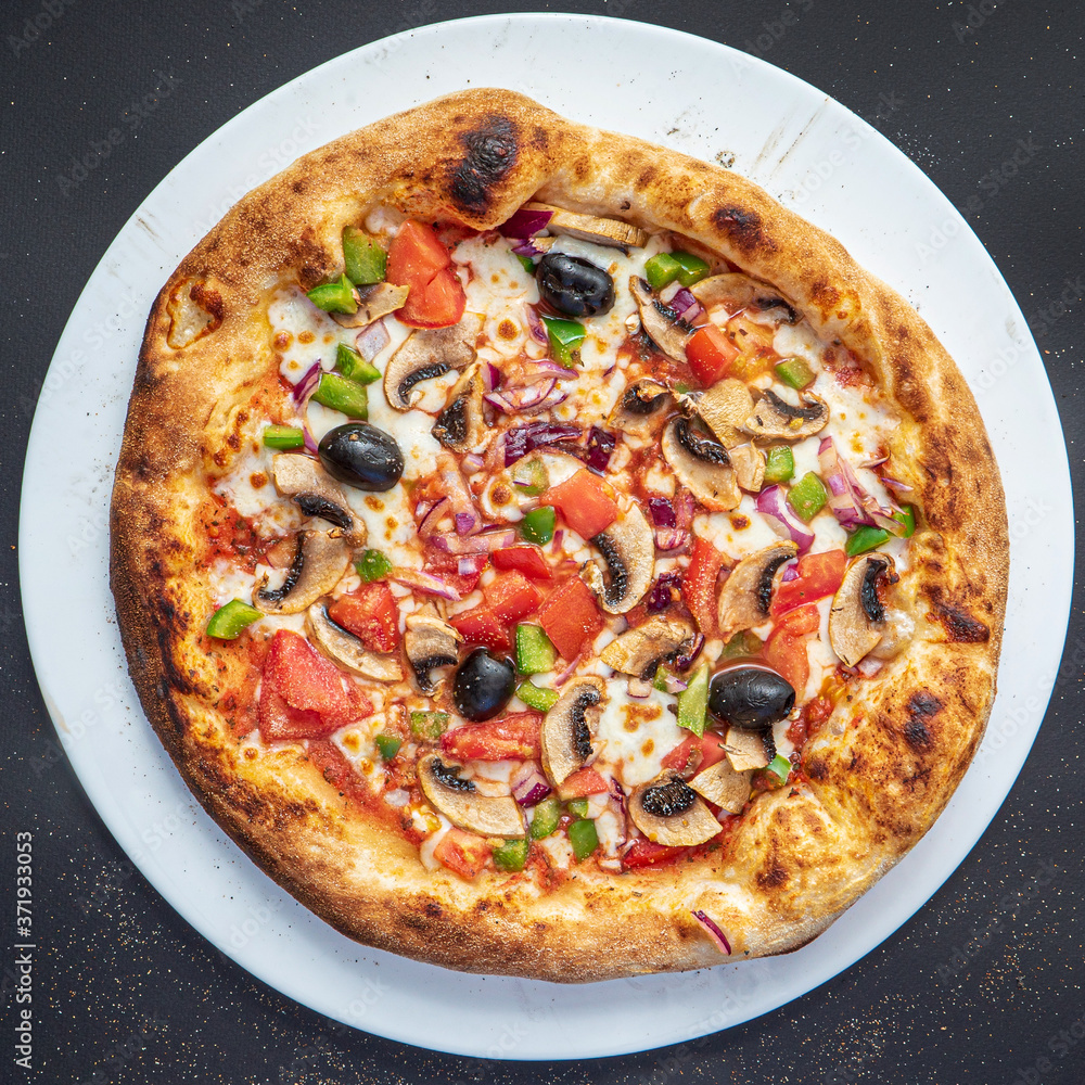 pizza on the black background, top view