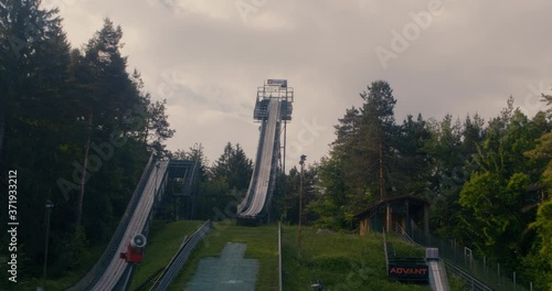 Aerial shot of ski jump Mostec in Ljubljana surrounded with forest photo