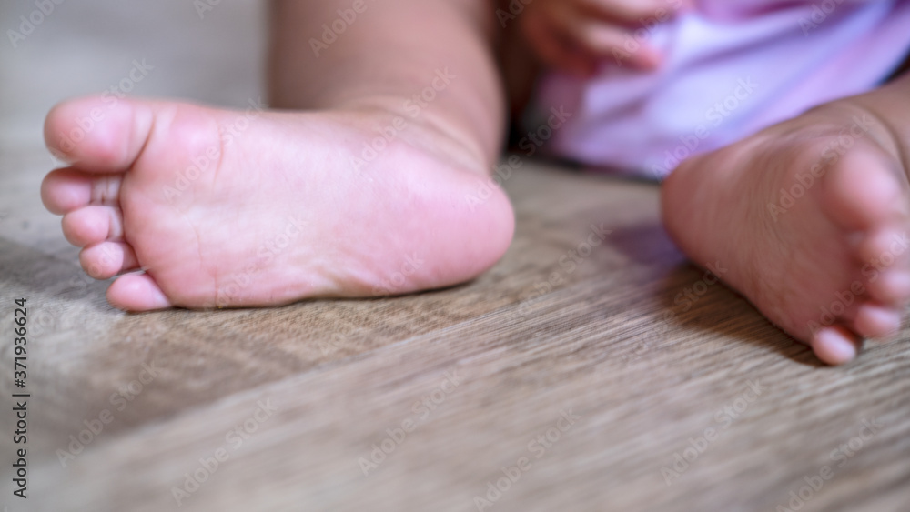 Baby feet on the wood floor. Toes horizontal photo. Baby feet on the wood floor. Toes horizontal photo.