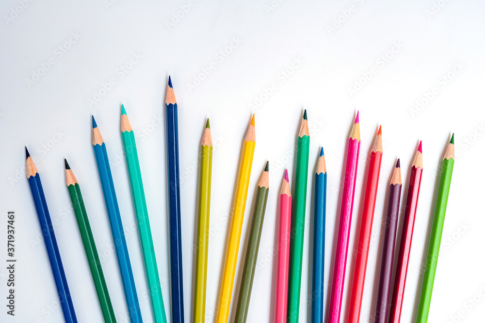 Fototapeta premium close-up of color pencils on white background, Color pencils isolated on white background. Equality concept, The idea is to use colored pencils to book a comparison of inequality in society.