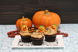 Chocolate cupcakes with peanut butter frosting decorated for Halloween.