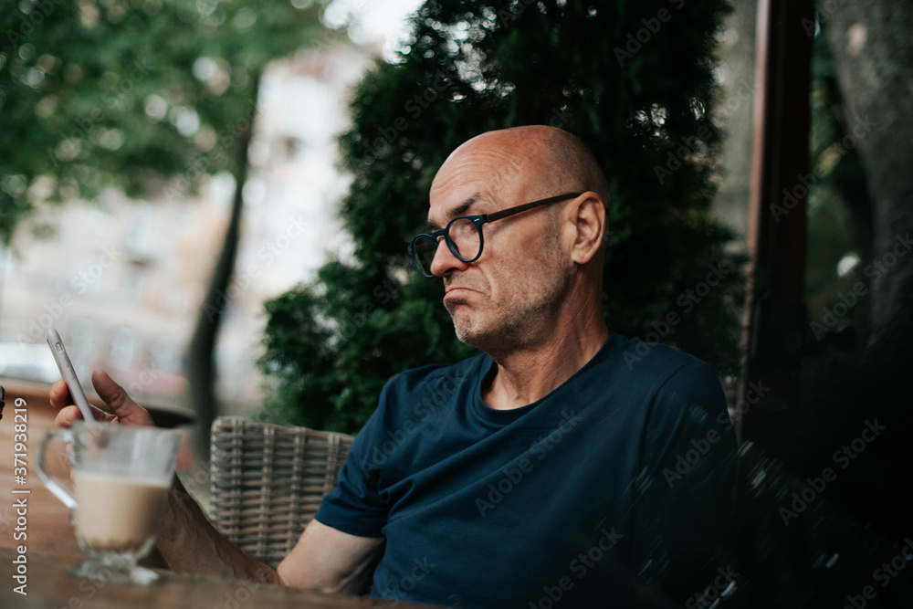 a business man sitting on the street drinking coffee a business man sitting on the street drinking coffee