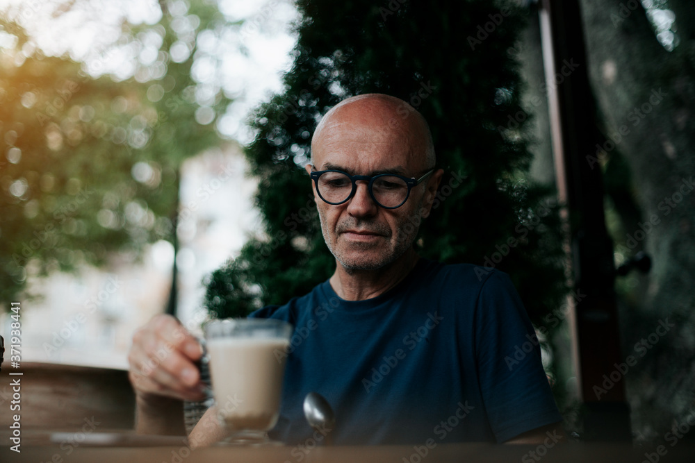 a business man sitting on the street drinking coffee a business man sitting on the street drinking coffee