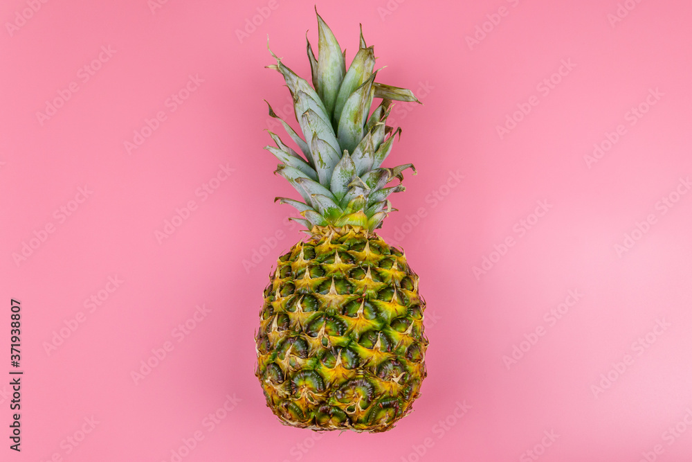 Fototapeta One whole pineapple on pink background. Top view
