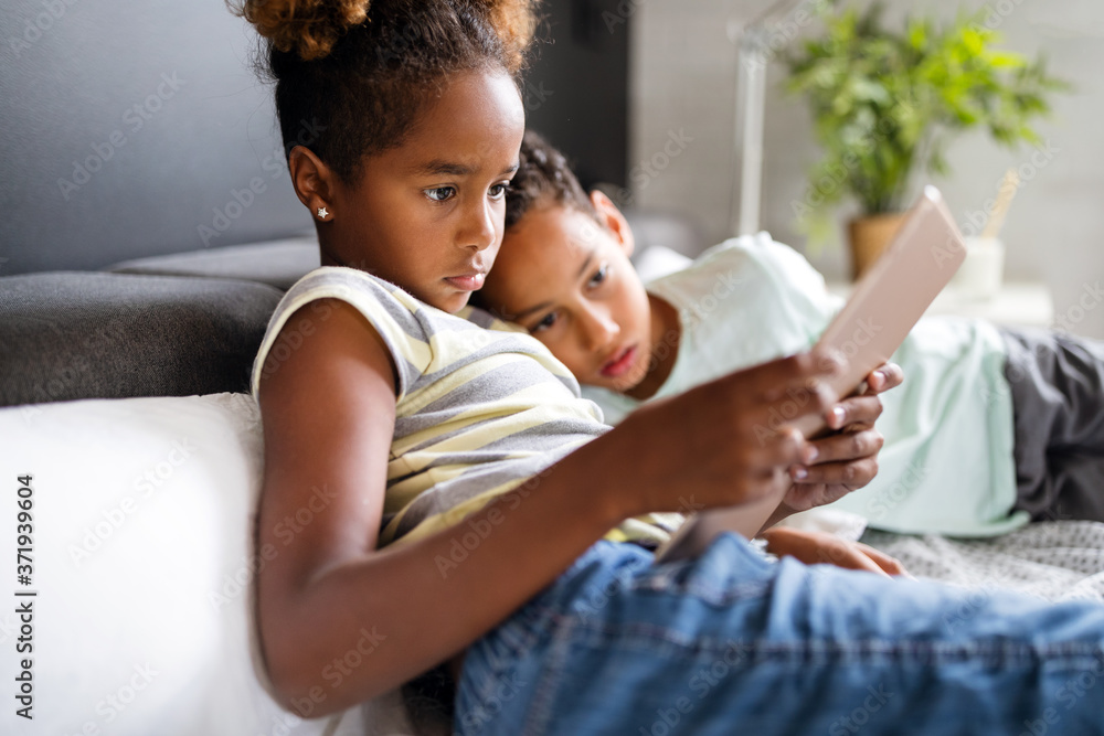 Happy children havig fun and using technology devices Happy children havig fun and using technology devices