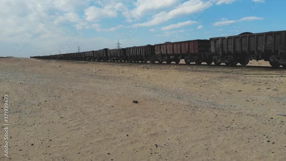 Train. Train in Mauritania. Train carrying coal. Industry in Mauritania. Filming from a drone. Footage. Mauritania in 4k. Africa in 4k Train. Train in Mauritania. Train carrying coal. Industry in Mauritania. Filming from a drone. Footage. Mauritania in 4k. Africa in 4k