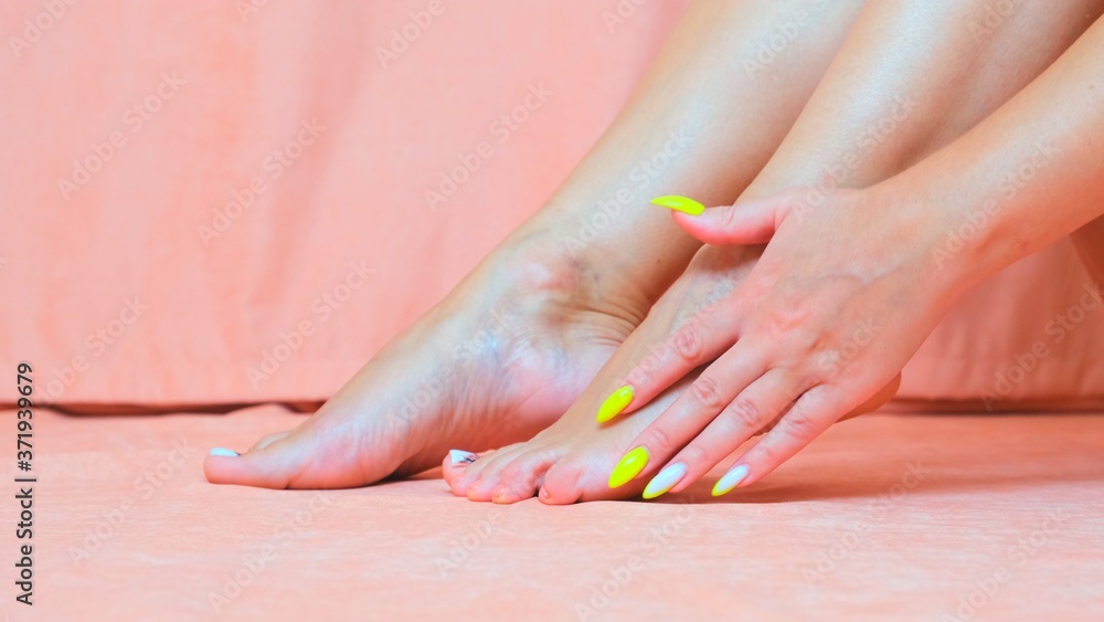 Naklejka premium Perfect clean female feet . Beautiful and elegant groomed girl's hand touching her foot . Spa ,scrub and foot care.