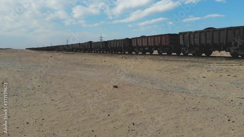 Train. Train in Mauritania. Train carrying coal. Industry in Mauritania. Filming from a drone. Footage. Mauritania in 4k. Africa in 4k