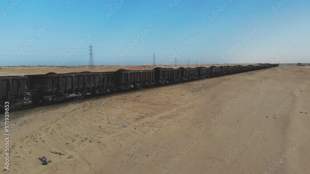 Train. Train in Mauritania. Train carrying coal. Industry in Mauritania. Filming from a drone. Footage. Mauritania in 4k. Africa in 4k Train. Train in Mauritania. Train carrying coal. Industry in Mauritania. Filming from a drone. Footage. Mauritania in 4k. Africa in 4k