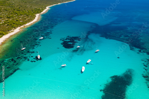 Amazing Adriatic sea in Croatia. Aerial view of azure turquoise lagoon on Sakarun beach on Dugi Otok island, yachts anchored blue sea, tourist paradise.