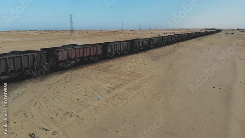 Train. Train in Mauritania. Train carrying coal. Industry in Mauritania. Filming from a drone. Footage. Mauritania in 4k. Africa in 4k