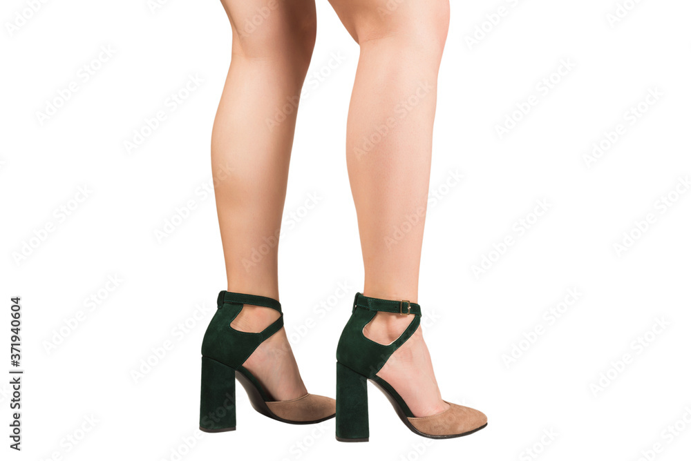 Woman legs in green and beige sandals on heels. Woman legs in green and beige sandals on heels.