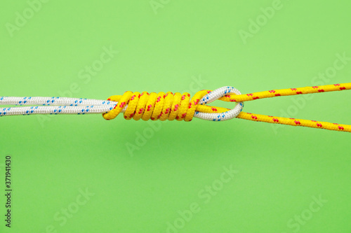 Ropes with knot on color background