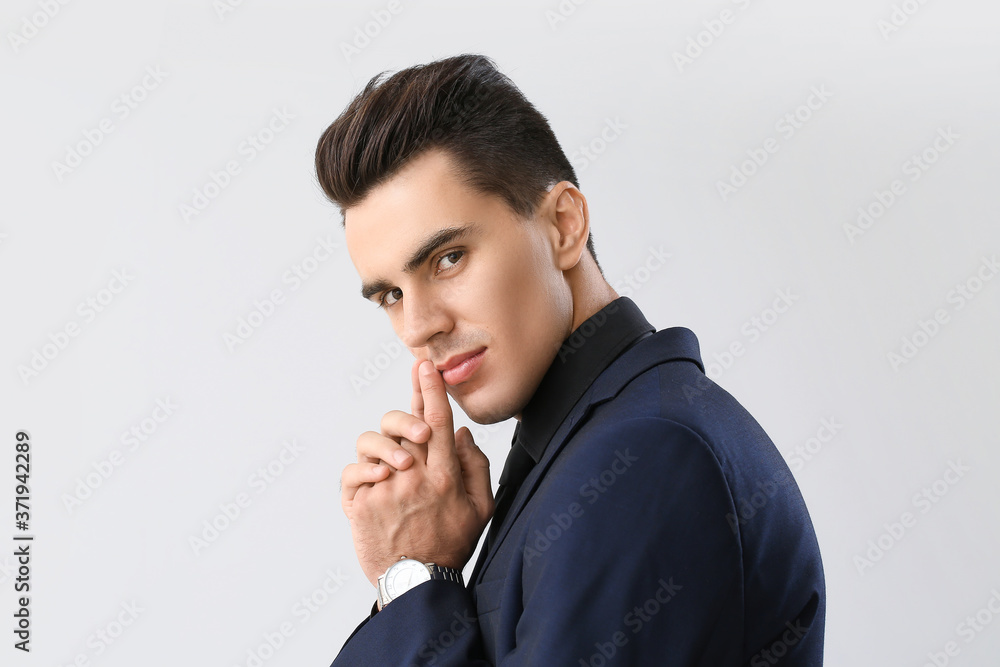 Handsome man with stylish hairdo on light background Handsome man with stylish hairdo on light background