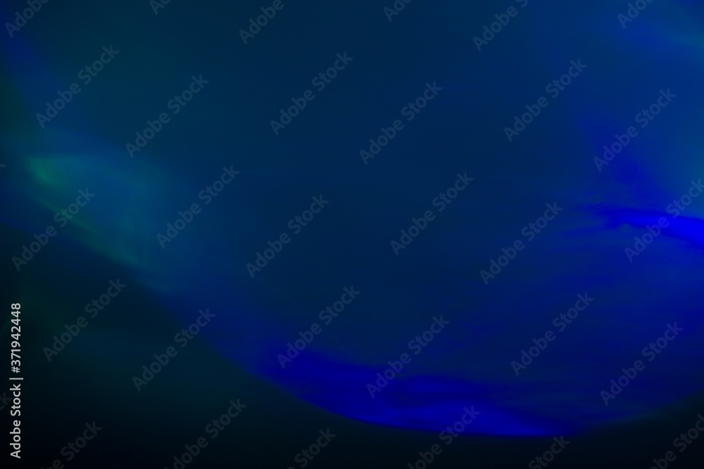 Fototapeta premium Blurred lens flare. Defocused colorful lights. Shiny glowing spots, abstract background and texture