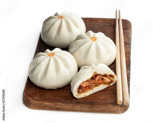 Steamed bao buns with delicious filling isolated on white photo