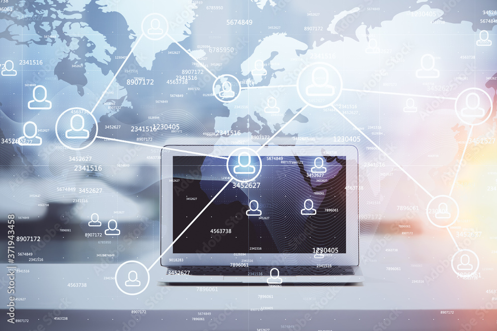 Fototapeta premium Computer on desktop with social network hologram. Double exposure. Concept of international people connections.