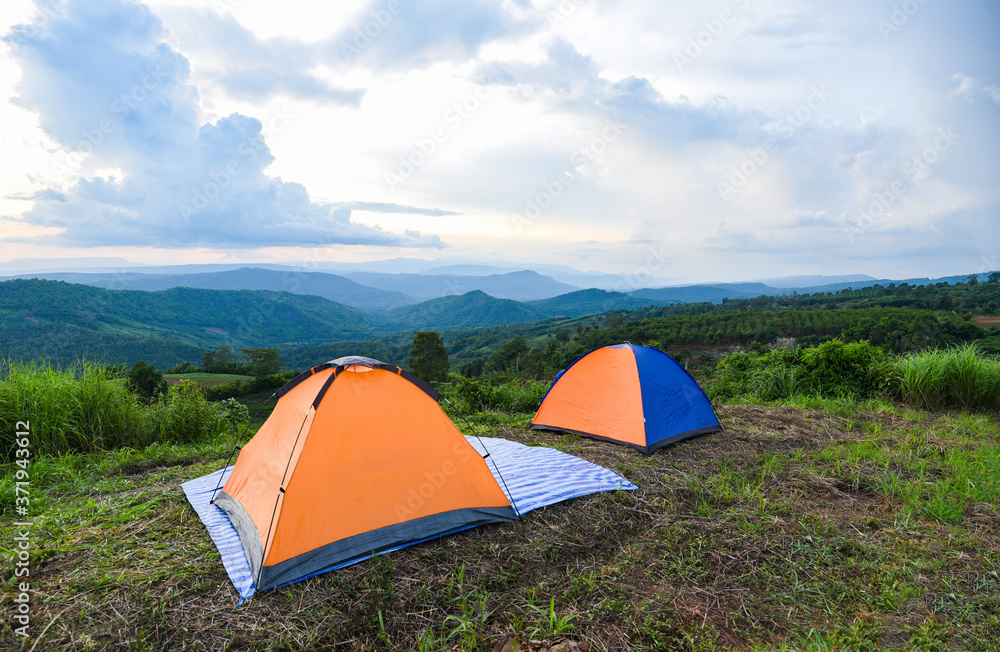 tent camping on the mountains landscape background - adventure travel camping tent in summer season