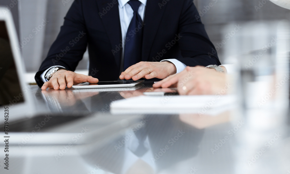 Business people working together at meeting in a modern office. Unknown businessman and woman with colleagues or lawyers at negotiation about contract Business people working together at meeting in a modern office. Unknown businessman and woman with colleagues or lawyers at negotiation about contract