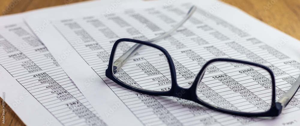 eyeglasses lying on a financial report with number tables on the office desk, business concept for finance
eyeglasses lying on a financial report with number tables on the office desk, business concept for finance