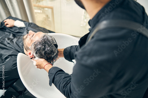 Focused photo on male hands that making foam
