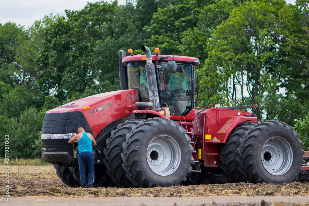 tractor driver near a large red tractor illustrative editorial
tractor driver near a large red tractor illustrative editorial