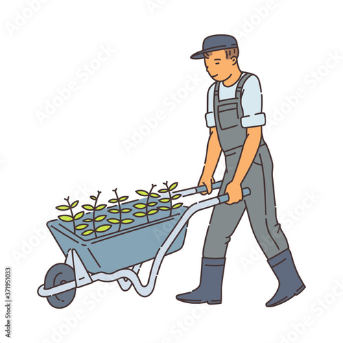 Farmer man walking with metal wheel barrow with green plants