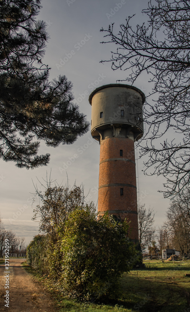 Old water tower made from bricks, next to a dirt road, in Hungary Old water tower made from bricks, next to a dirt road, in Hungary