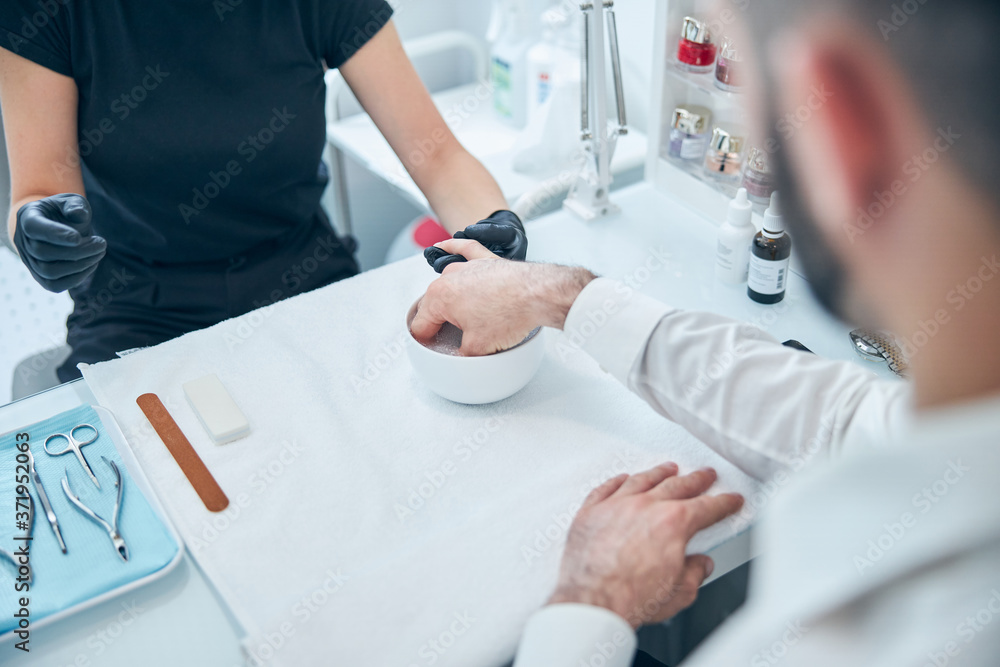 Obraz premium Close up of bearded man keeping hand in water