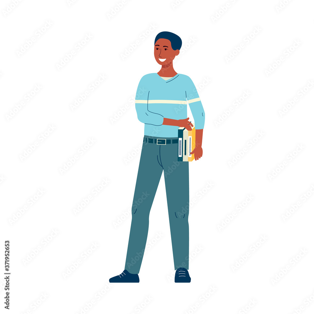 Young male African student with books standing and smiling Young male African student with books standing and smiling